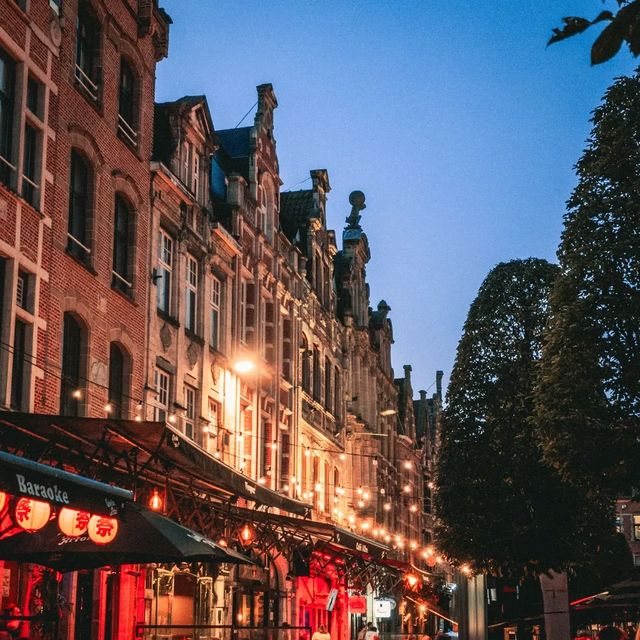 Evening lights, old bricks, and soft skies. · Leuven, Belgium